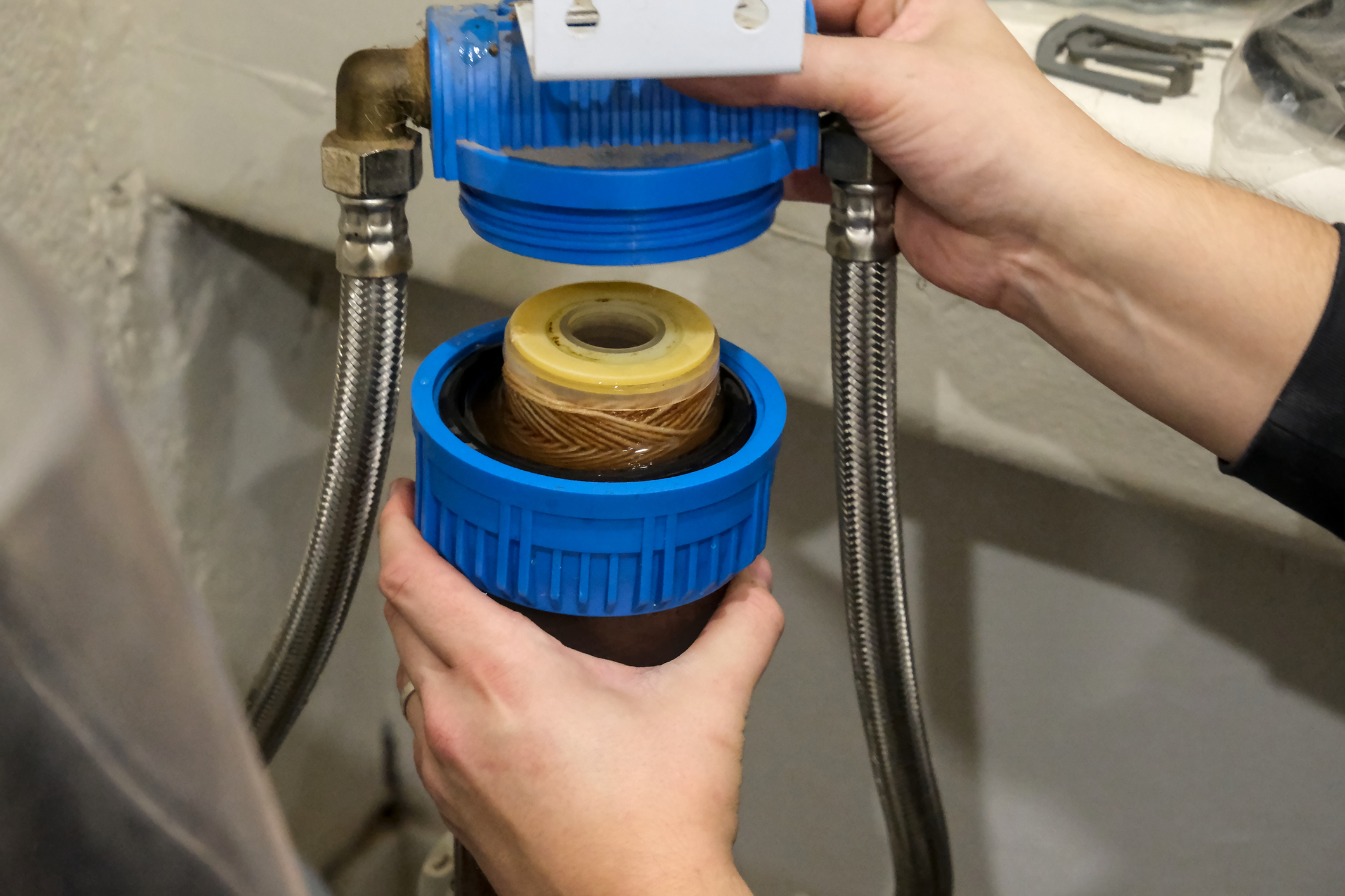 Plumber servicing a water softener and replacing the filter